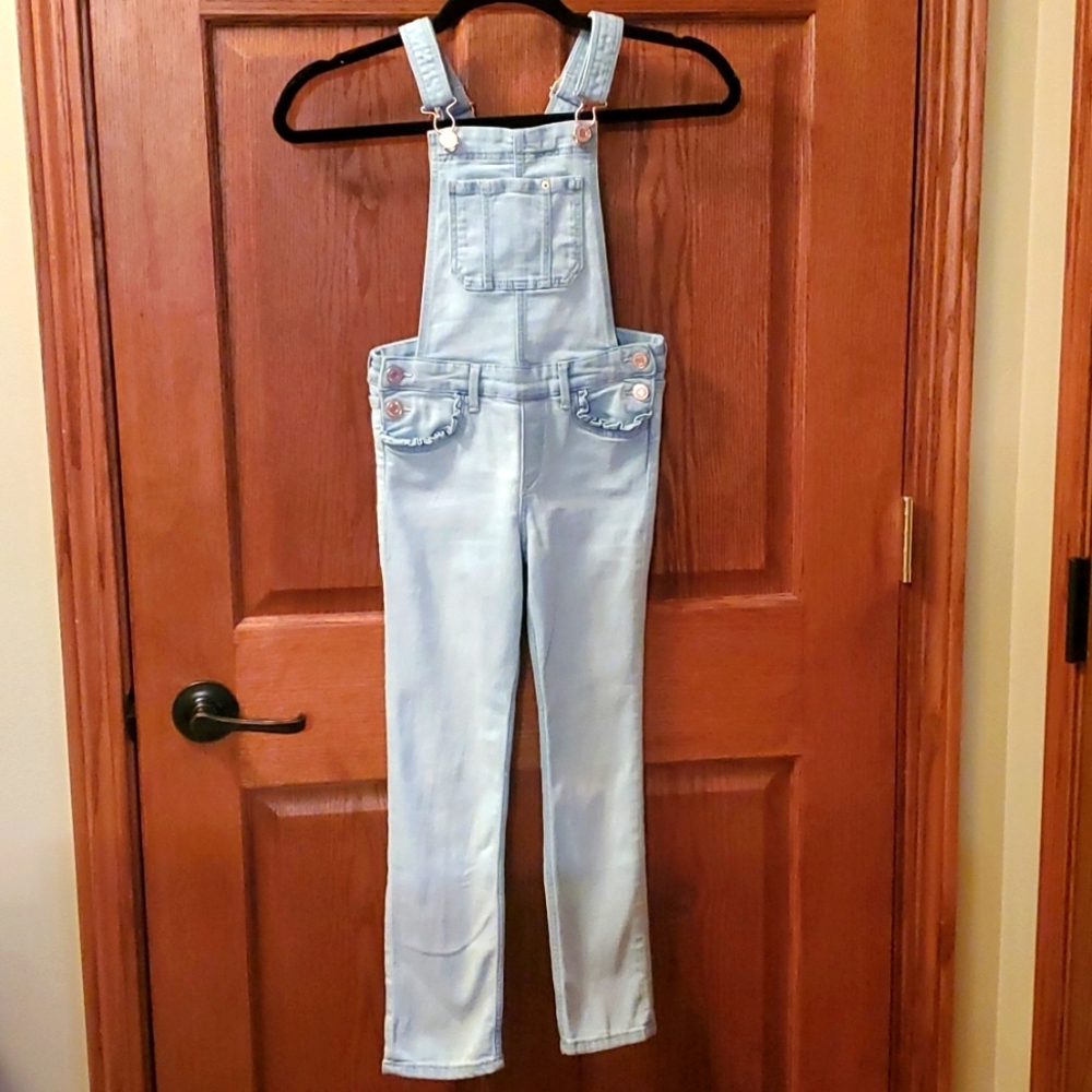 Girls light denim overalls.